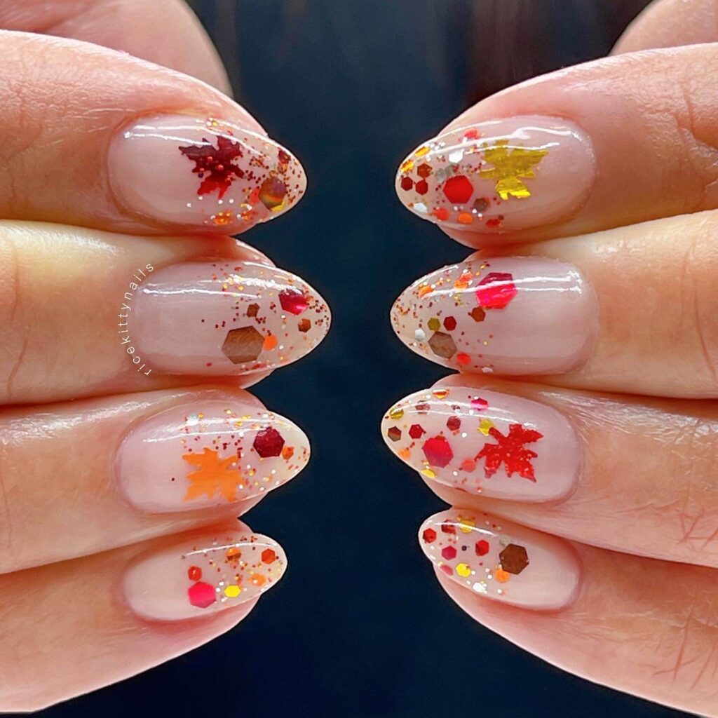 Close-up of warm-toned pumpkin spice nails with a fall-inspired design.