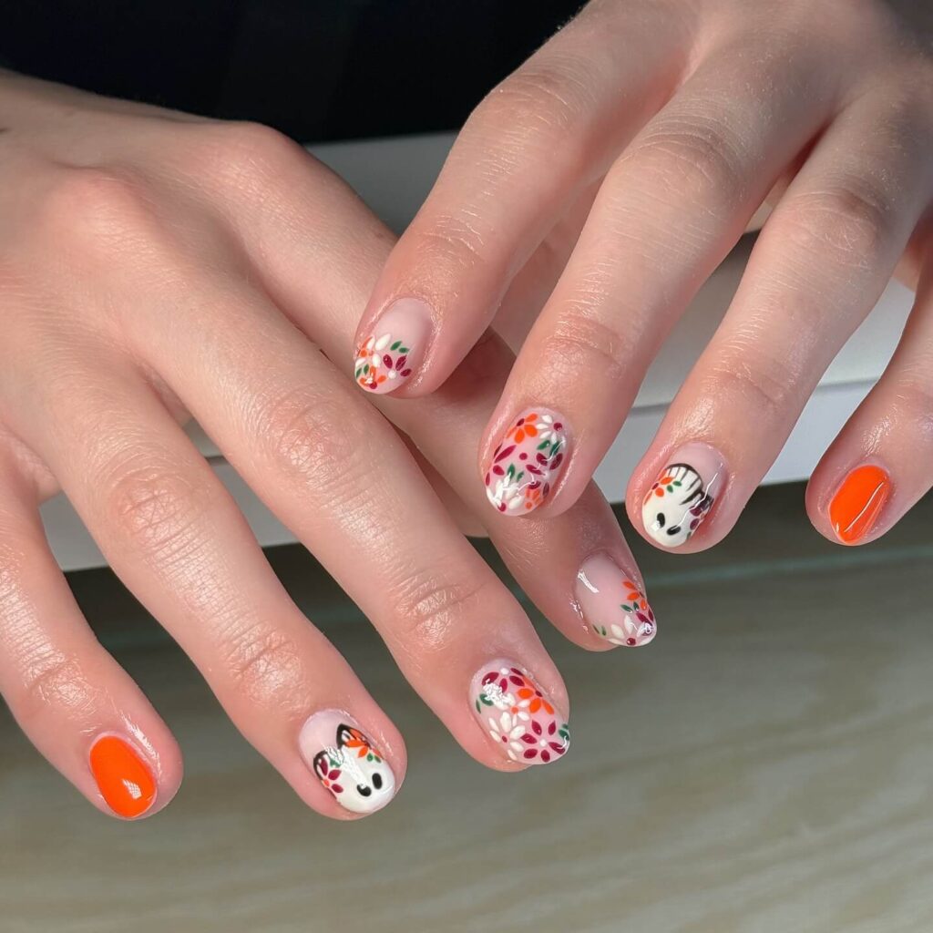 Close-up of warm-toned pumpkin spice nails with a fall-inspired design.