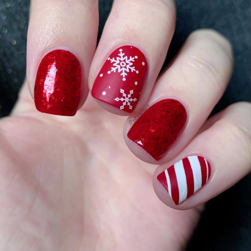 candy cane nails with red and white stripes and glitter accents, perfect for a festive holiday look.