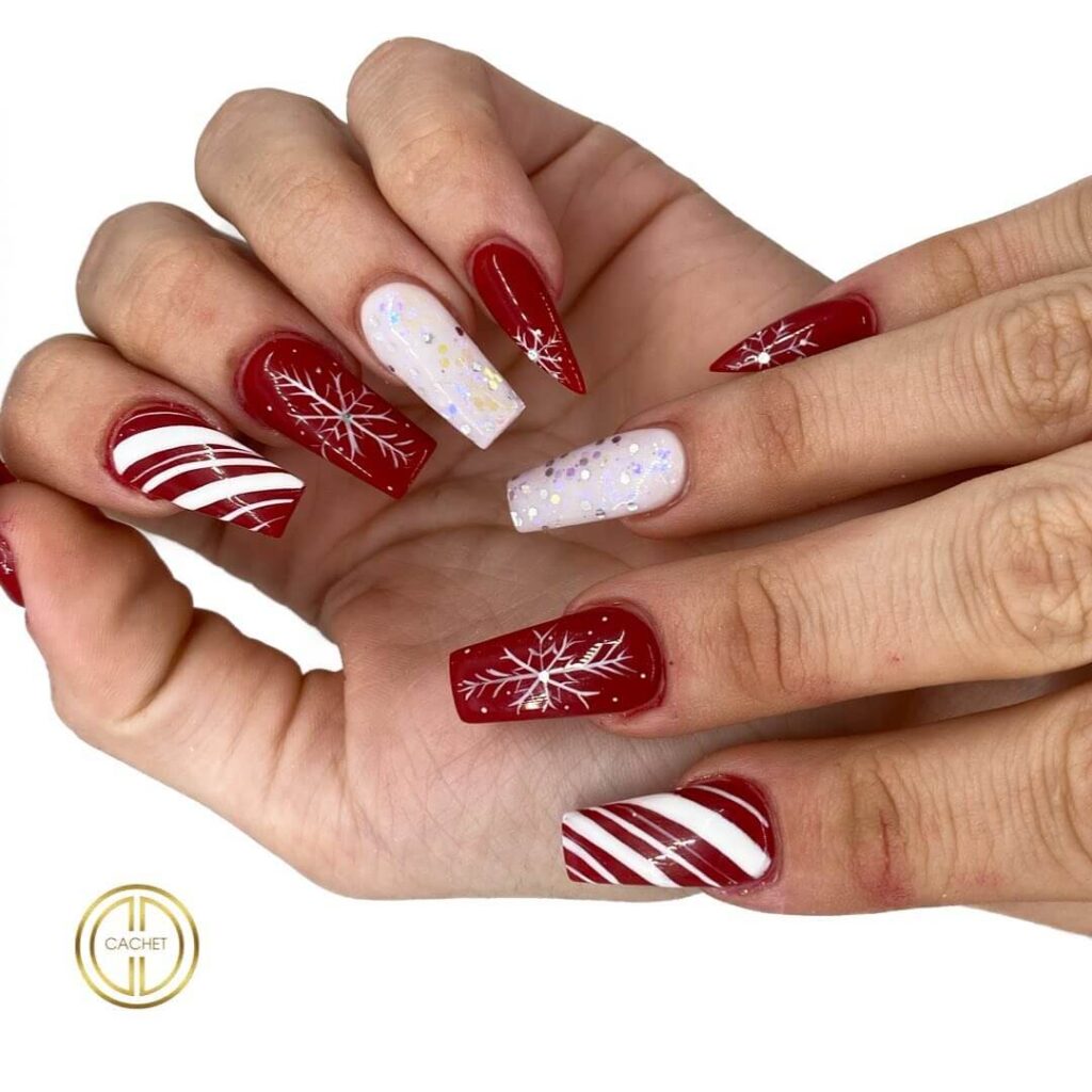 candy cane nails with red and white stripes and glitter accents, perfect for a festive holiday look.