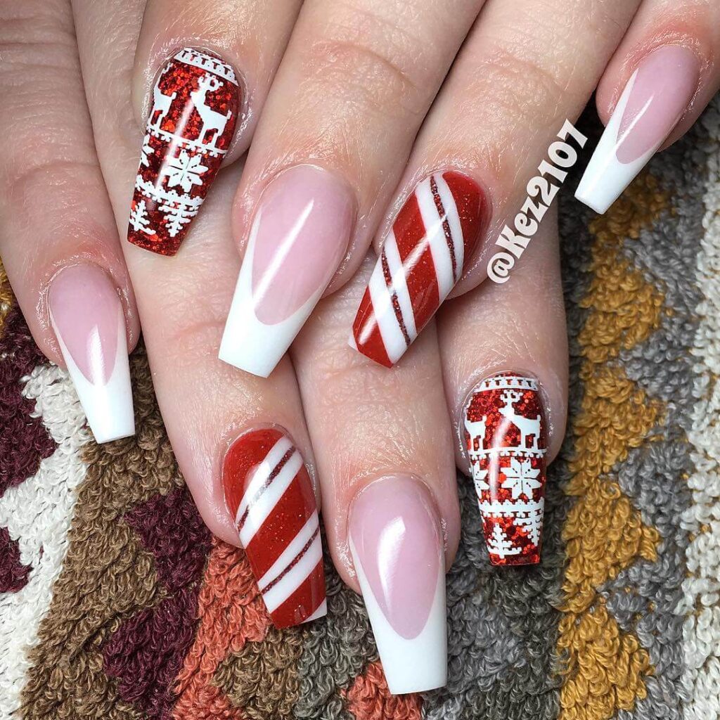 candy cane nails with red and white stripes and glitter accents, perfect for a festive holiday look.