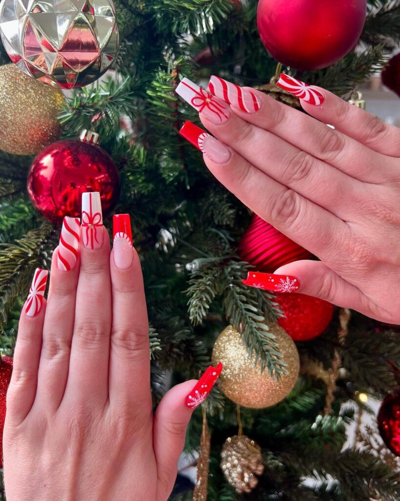 candy cane nails with red and white stripes and glitter accents, perfect for a festive holiday look.