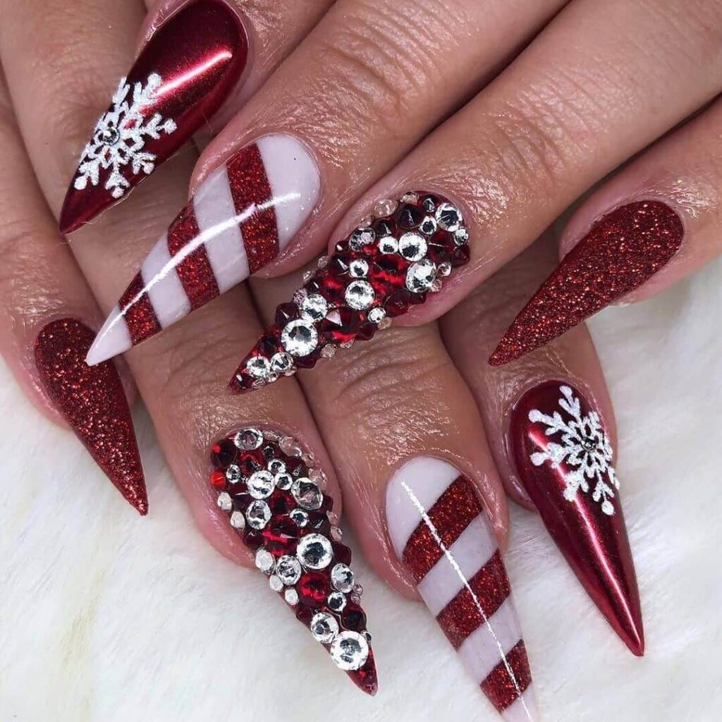 candy cane nails with red and white stripes and glitter accents, perfect for a festive holiday look.