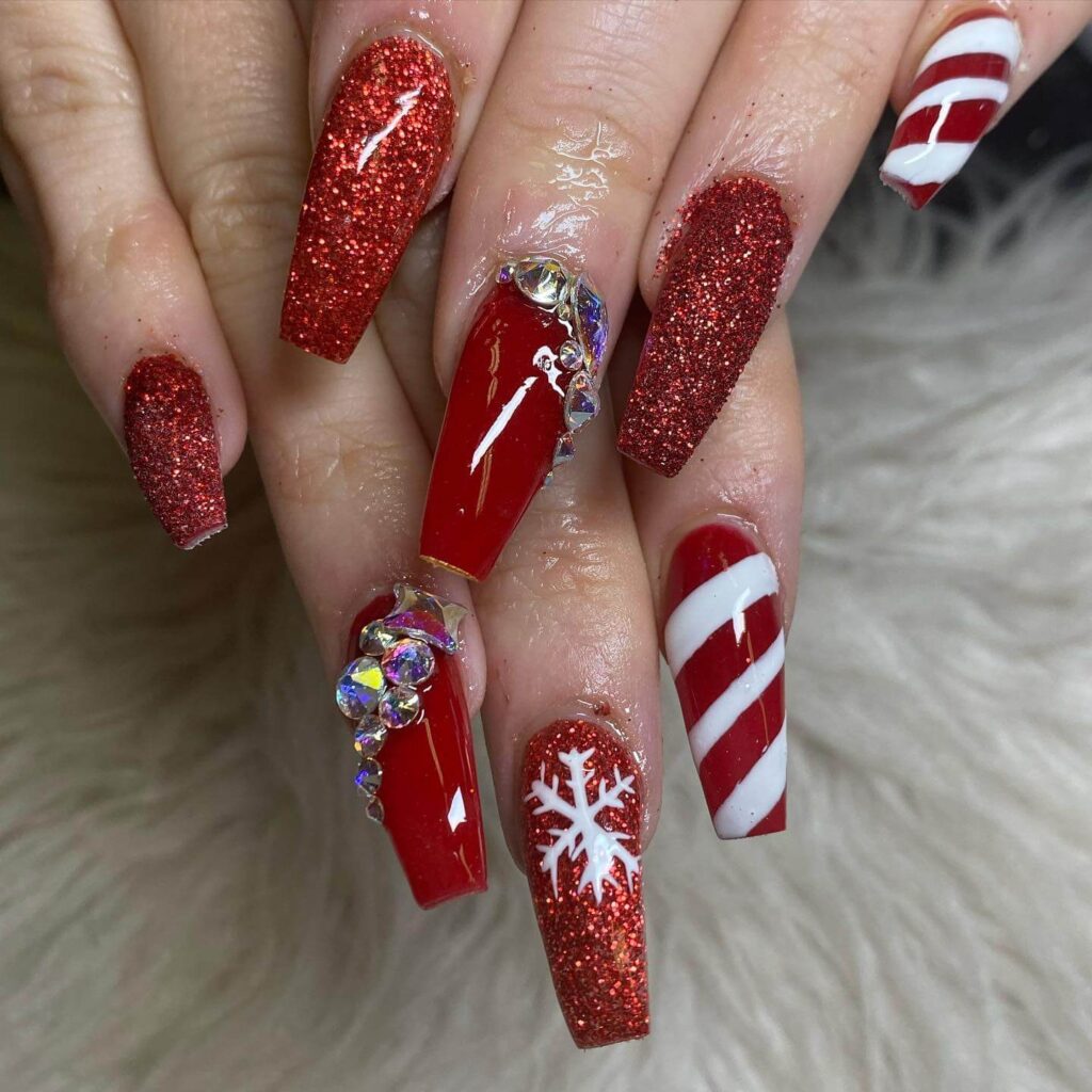 candy cane nails with red and white stripes and glitter accents, perfect for a festive holiday look.