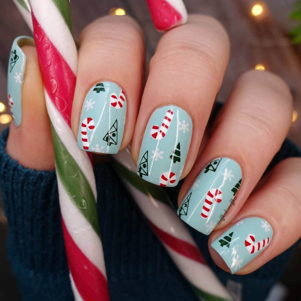 candy cane nails with red and white stripes and glitter accents, perfect for a festive holiday look.