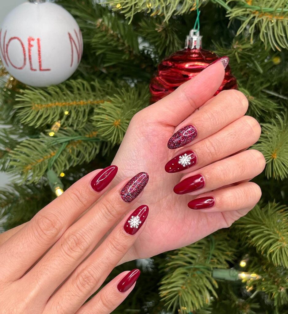 Festive Christmas gel nails featuring red, green, and white designs, including snowflakes, candy cane stripes, and Christmas tree accents.