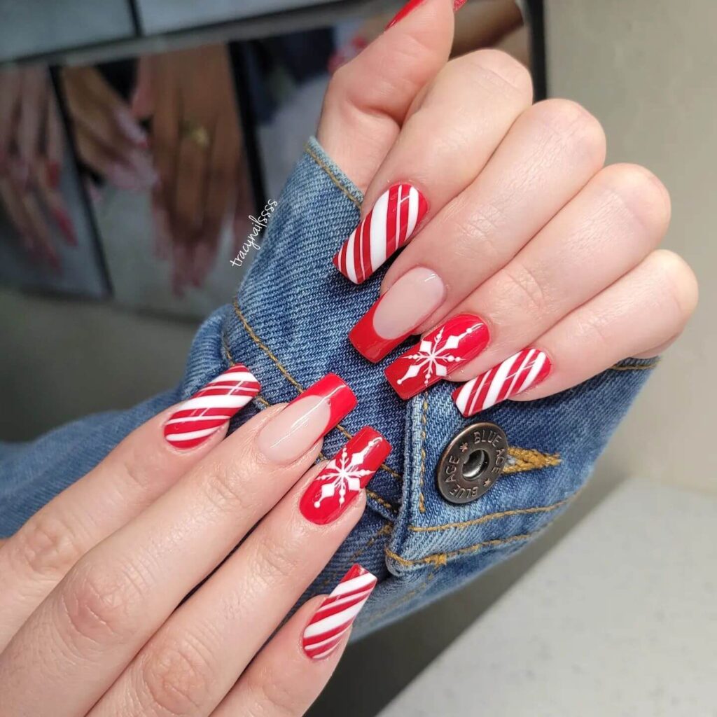 Festive Christmas gel nails featuring red, green, and white designs, including snowflakes, candy cane stripes, and Christmas tree accents.