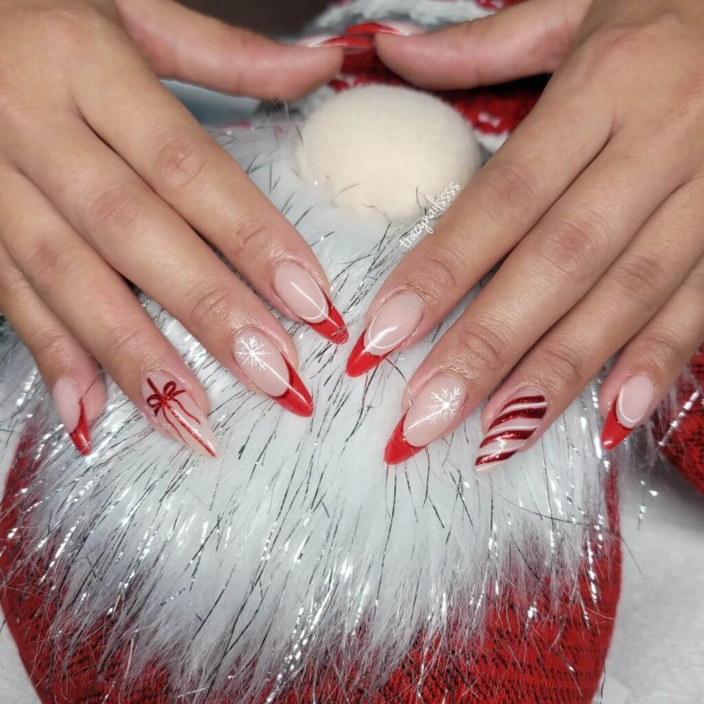 Festive Christmas gel nails featuring red, green, and white designs, including snowflakes, candy cane stripes, and Christmas tree accents.