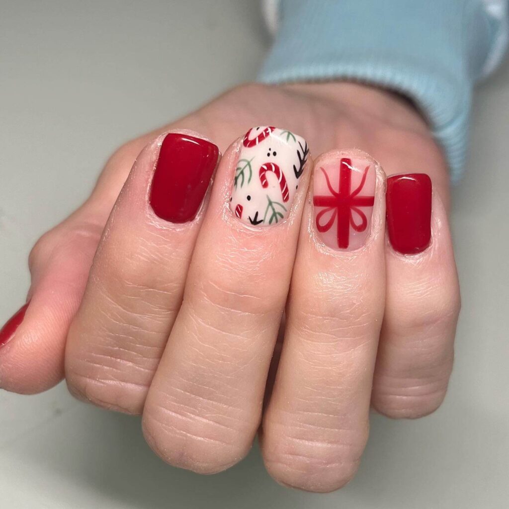 Festive Christmas gel nails featuring red, green, and white designs, including snowflakes, candy cane stripes, and Christmas tree accents.