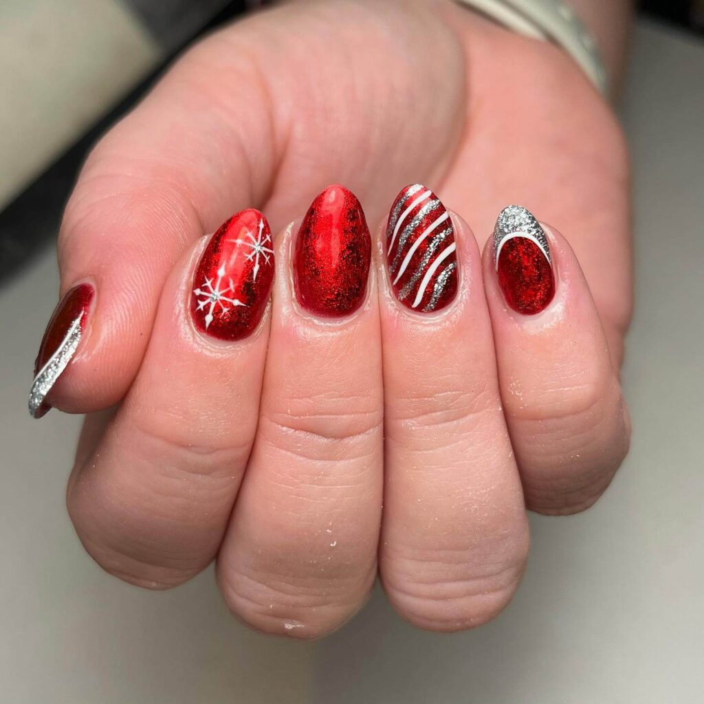 Festive Christmas gel nails featuring red, green, and white designs, including snowflakes, candy cane stripes, and Christmas tree accents.