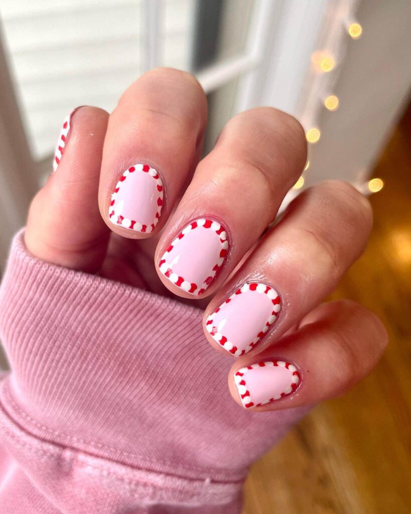 Festive Christmas nail art designs featuring snowflakes, candy cane stripes, and gingerbread nail details.