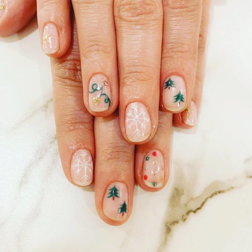 Festive Christmas nail art designs featuring snowflakes, candy cane stripes, and gingerbread nail details.