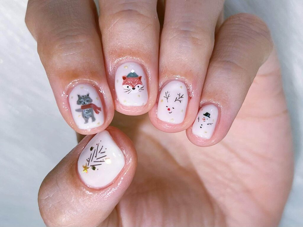 Festive Christmas nail art designs featuring snowflakes, candy cane stripes, and gingerbread nail details.