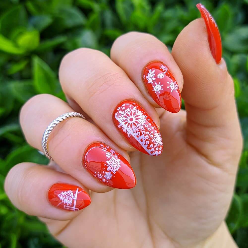 Festive Christmas nail designs featuring red and green nails with glitter accents, snowflakes, and holiday-themed nail art.