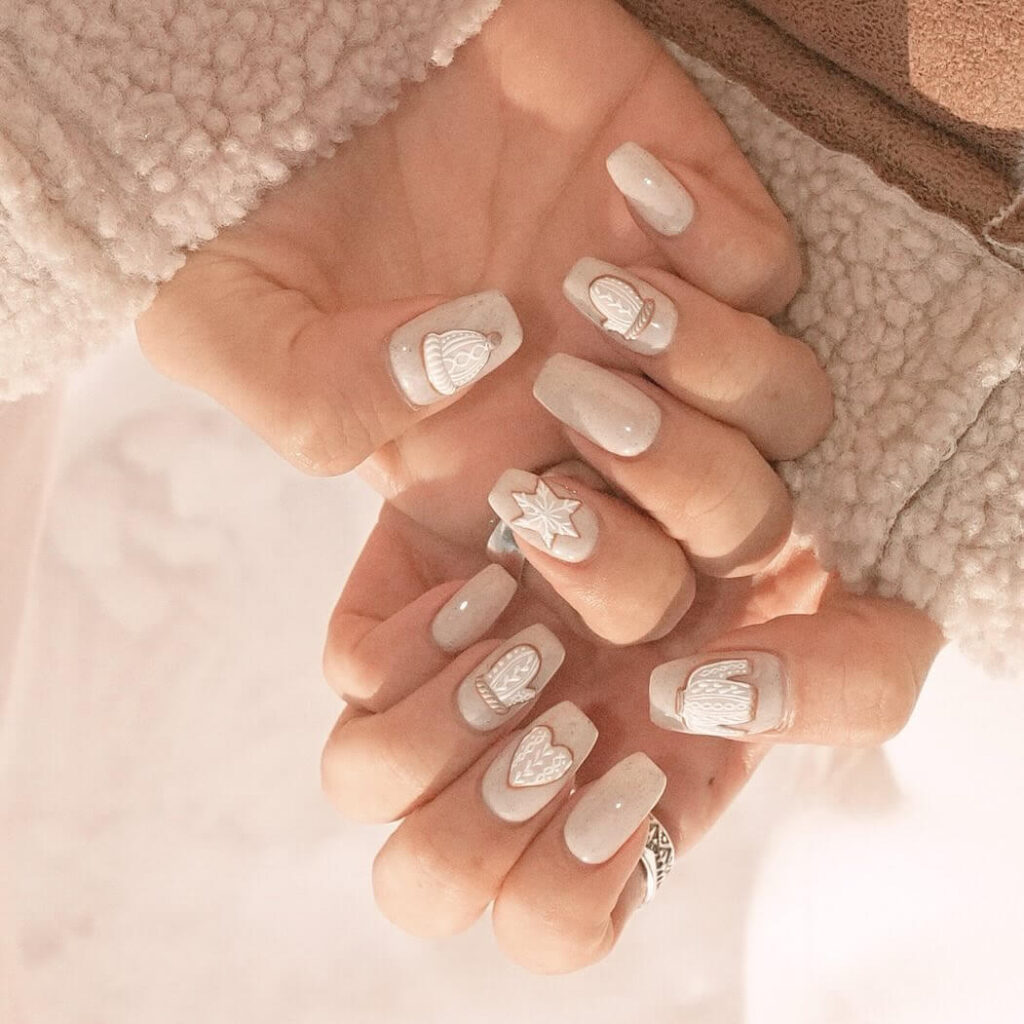 elegant winter nails with blue Christmas nails and delicate snow nail art, perfect for the festive season.