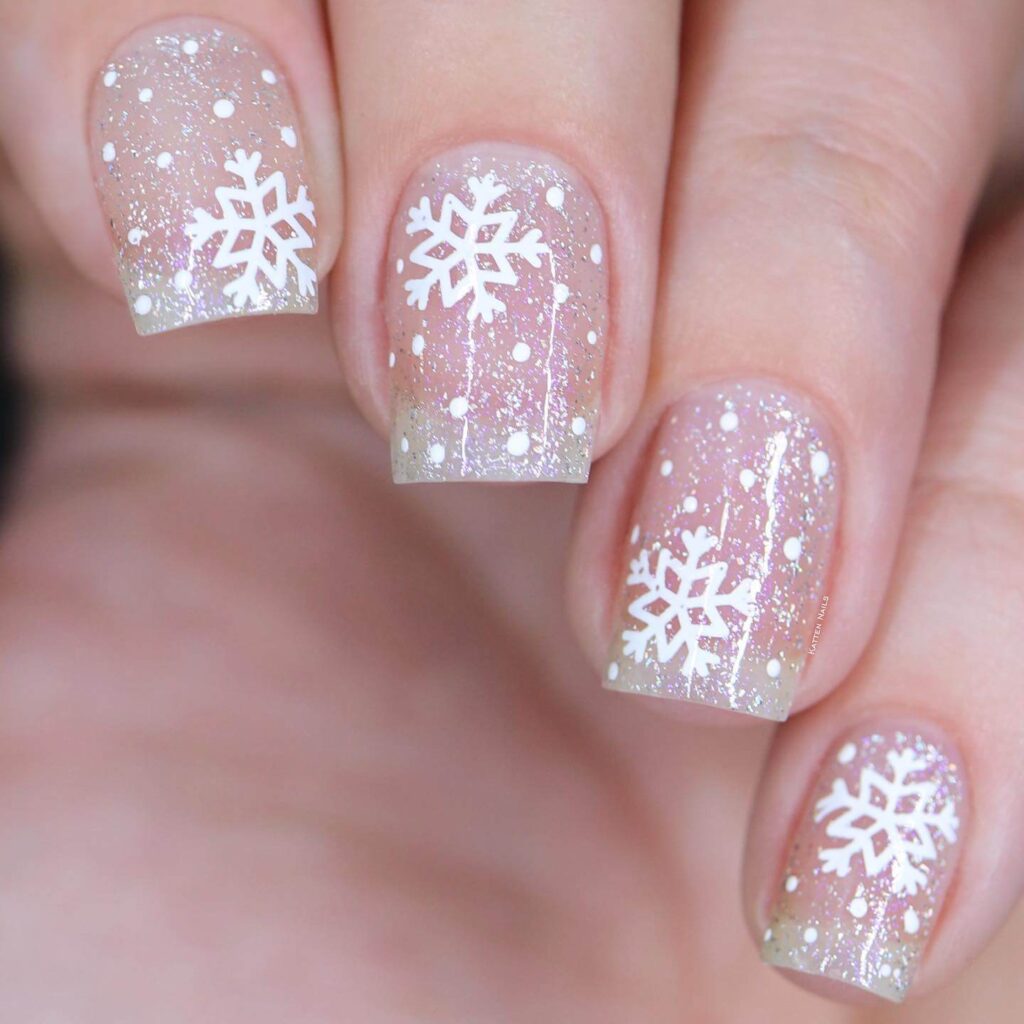 elegant winter nails with blue Christmas nails and delicate snow nail art, perfect for the festive season.