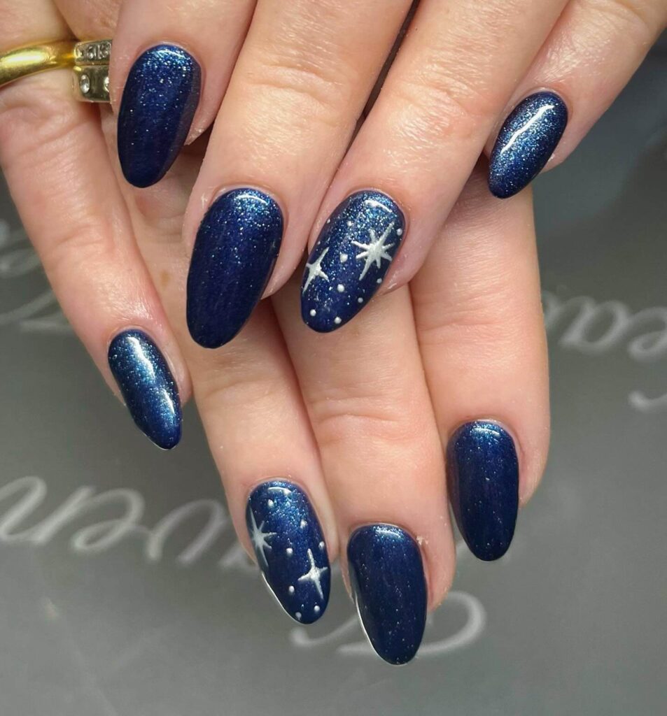 elegant winter nails with blue Christmas nails and delicate snow nail art, perfect for the festive season.