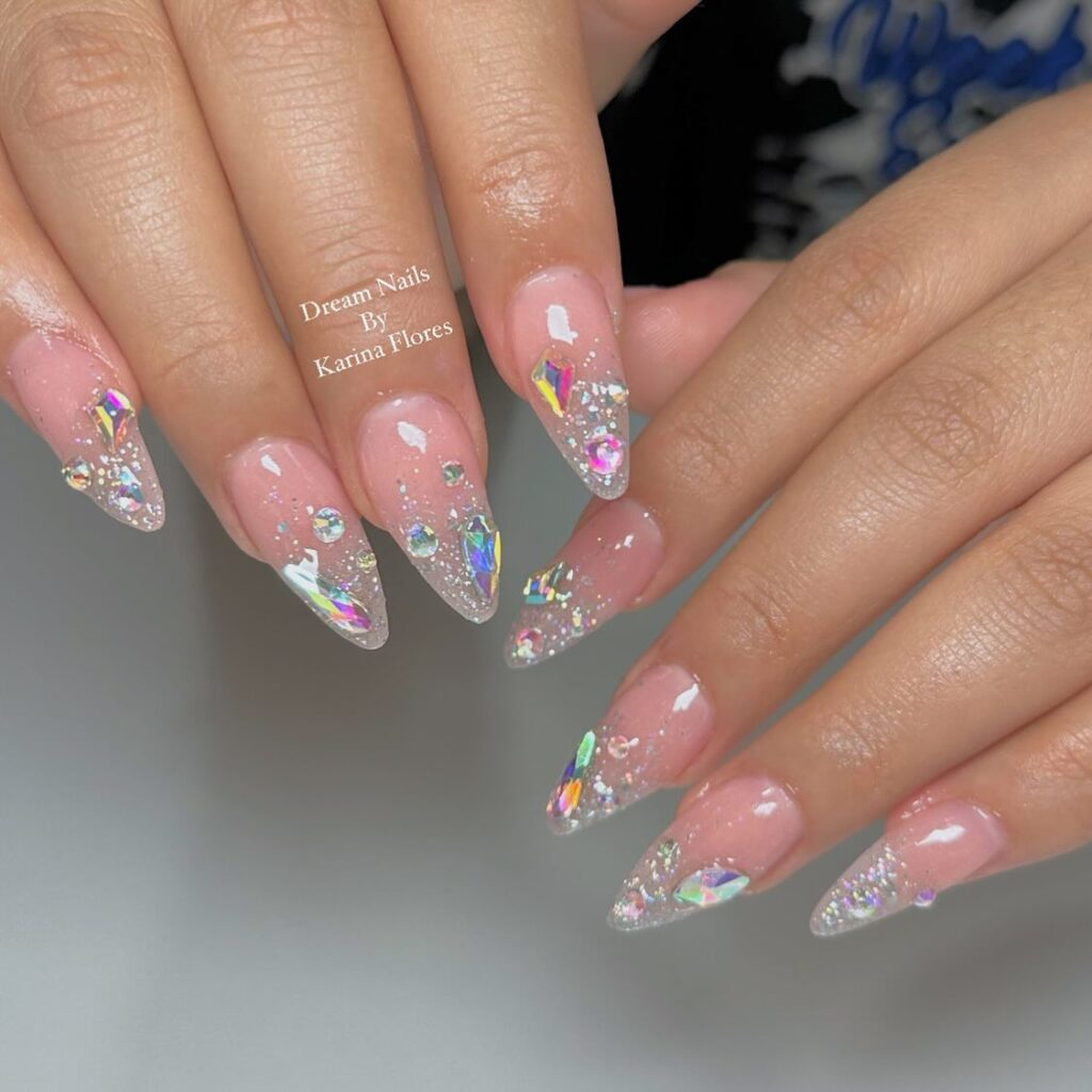 Shine with Swarovski nails! From subtle nude designs to bold blue and pink rhinestones, explore dazzling nail art perfect for every occasion and style.